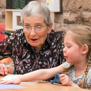 An elderly lady with a young girl