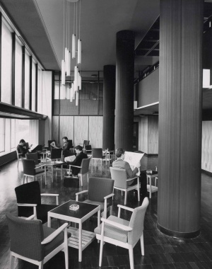 Male students sitting in a common area in High Hall in the 1960s, with many chairs around tables with ashtrays